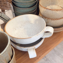 Load image into Gallery viewer, Set of ceramic bowls and mugs on a wooden shelf
