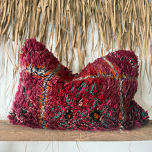 Load image into Gallery viewer, Decorative pillow with a textured pattern on a wooden shelf against a natural woven wall.
