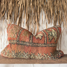 Load image into Gallery viewer, Decorative pillow with intricate patterns on a wooden shelf against a thatched wall.
